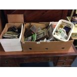 A box containing jewellery, cameras, postcards etc