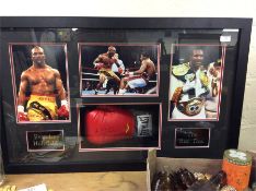 An Evander Holyfield boxing glove in boxed frame,