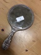 A silver embossed top mirror.