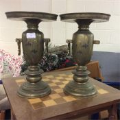 A pair of brass vases.