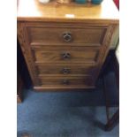 A oak reproduction chest of four drawers.