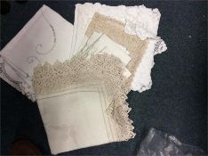 A collection of lace tablecloths and place mats.