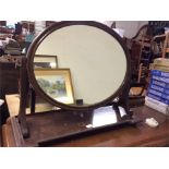 A mahogany toilet mirror.