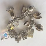 A good heavy silver charm bracelet with padlock cl