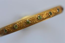 A peridot bangle, the body attractively decorated