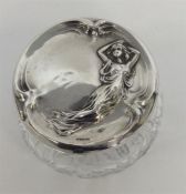 A stylish silver topped jar in the form of a lady