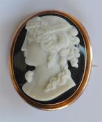 A large hard stone cameo of a lady's head in gold