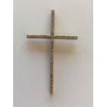 A diamond cross set in gold. Approx. 5 cms high. A