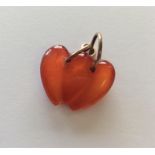 A Corneliun carved double heart charm with loop to