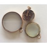 A large circular pearl mounted gold locket with lo