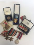A bag containing numerous boxed medals and coins.