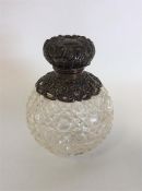 A circular hobnail cut scent bottle with hinged de
