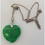 A large jade heart shaped pendant with 18 carat go
