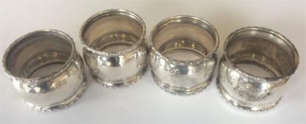 A set of four circular napkin rings with reeded de