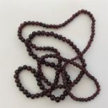 A long graduated string of garnet beads. Approx. 5