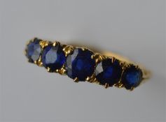 A good sapphire five stone half hoop ring in 18 ca