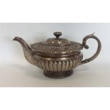 A Scottish half fluted silver teapot with scrolls