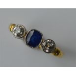 A sapphire and diamond three stone ring in 18 cara