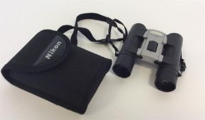 NIKON: A pair of sport lite 10 x 25 binoculars. Es