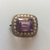 A Victorian amethyst brooch with pearl and seed pe