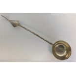 An Eastern ladle with scroll and leaf decoration.
