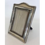 A large arched top picture frame with reeded decor