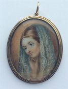 An oval miniature of a lady in gold frame with hai