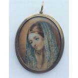 An oval miniature of a lady in gold frame with hai