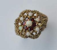 A modern 9 carat opal and garnet cluster ring. App