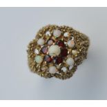 A modern 9 carat opal and garnet cluster ring. App