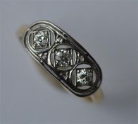 An attractive Edwardian three stone diamond ring i