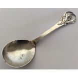 A Continental scroll decorated spoon mounted with