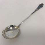 A Continental serving spoon with engraved blade. A