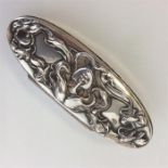 An oval sterling embossed top pin box decorated wi