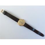 A gent's gold sovereign wristwatch with date apert