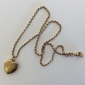 A 9 carat heart shaped locket on fine link chain w