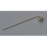 A boxed pearl stick pin in gold. Est. £50 - £80.