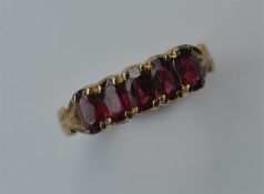 A garnet five stone half hoop ring. Approx. 2.3 gr