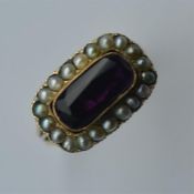 An amethyst and seed pearl ring in gold mount. App