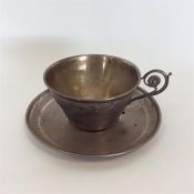 A Russian engine turned cup and saucer with floral