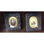 A pair of carved wooden miniatures in frame.