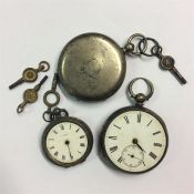 A group of silver pocket watches together with key