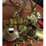 A large collection of brass and other candlesticks