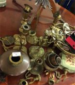 A large collection of brass and other candlesticks