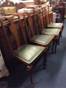 A set of four Queen Anne style dining chairs.