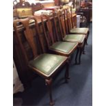 A set of four Queen Anne style dining chairs.