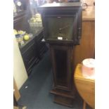 An oak Grandmother clock with brass dial.