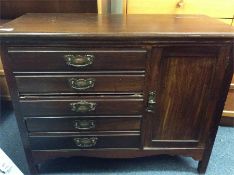 An Edwardian five drawer cupboard.