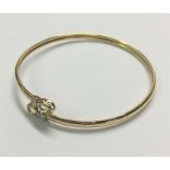 A gold peridot torque bangle.