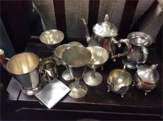 A collection of nickel and brass ware.